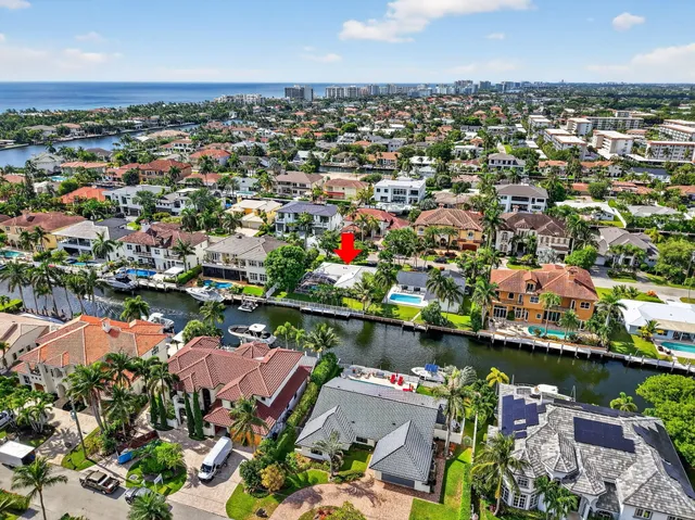 an aerial view of a houses with a lake