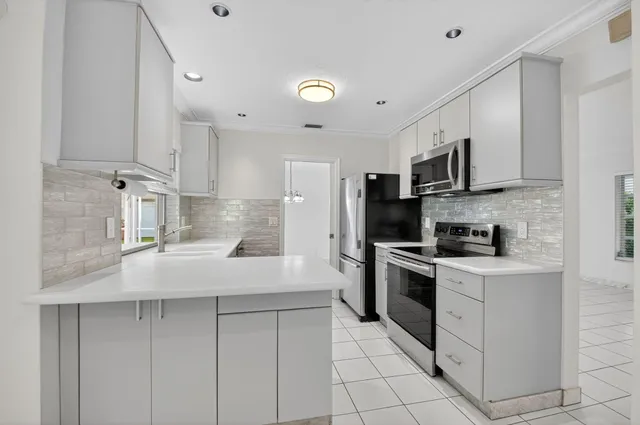 a kitchen with stainless steel appliances granite countertop a sink and cabinets