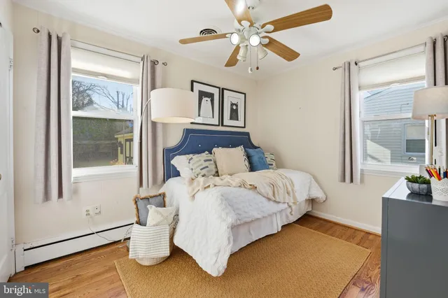 a bed sitting in a bedroom next to a window