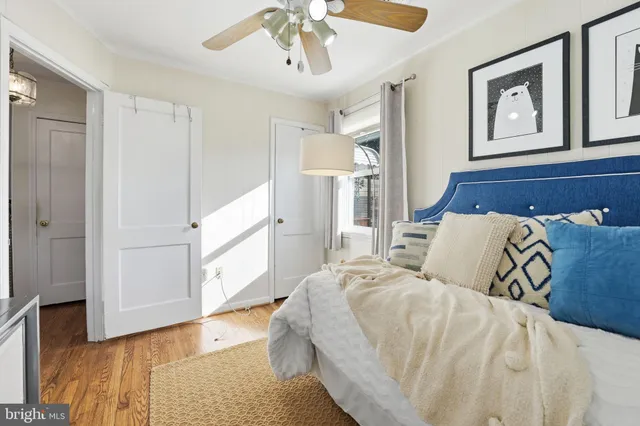 a bedroom with a large bed and a chandelier
