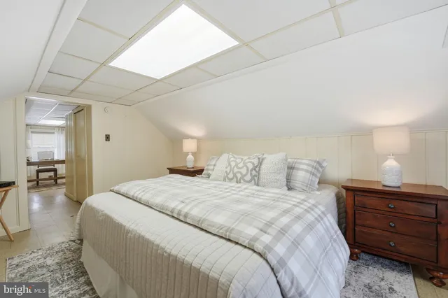 a bedroom with a bed and a mirror