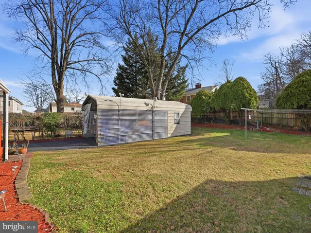 a view of a garden with large trees