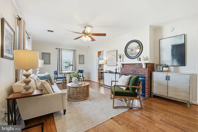a living room with furniture a clock and a fireplace