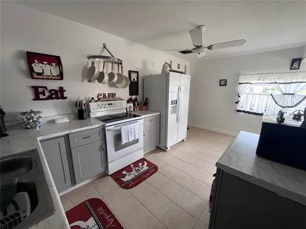 a kitchen with stainless steel appliances a stove a refrigerator and cabinets