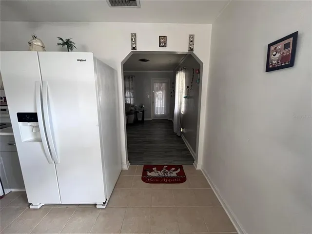 a view of a hallway with entryway and furniture