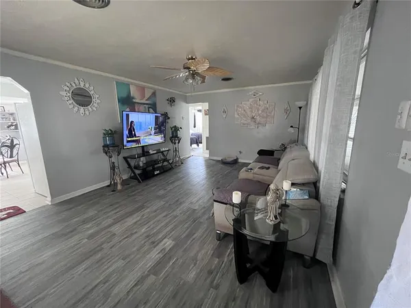 a living room with furniture and a chandelier