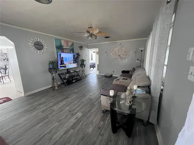 a living room with furniture and a chandelier