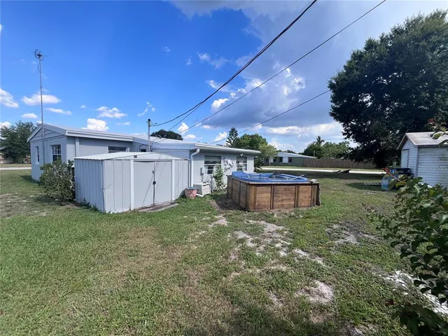 a view of a backyard with plants and a patio