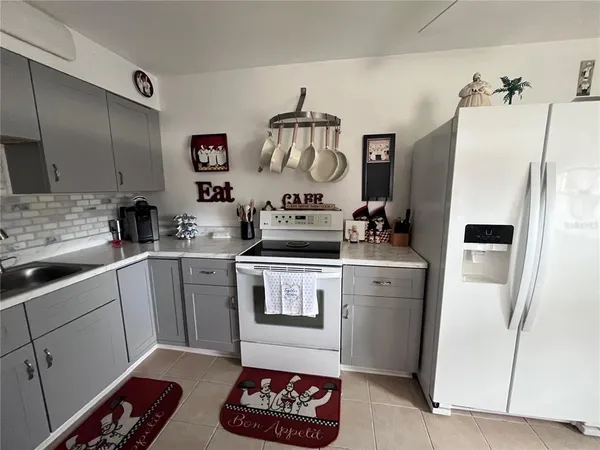 a kitchen with a refrigerator and a stove