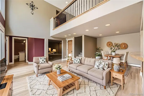 a living room with furniture and wooden floor