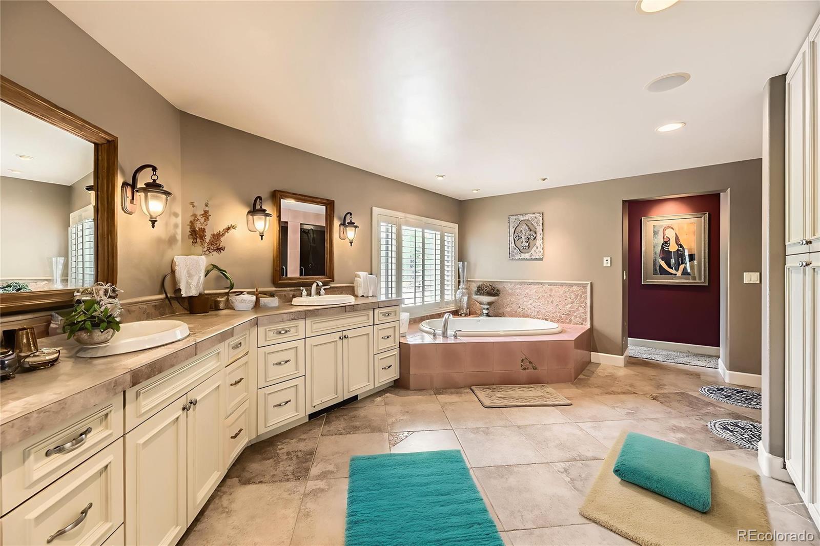 11274 East Manitou Road Franktown, CO 80116 - Photo 19 of 46 a large spacious bathroom with a granite countertop tub and a sink