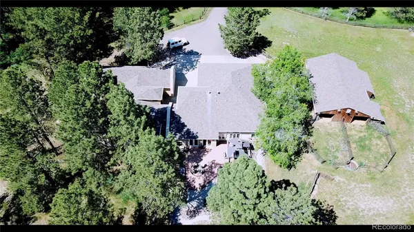 an aerial view of a house with a yard and garden