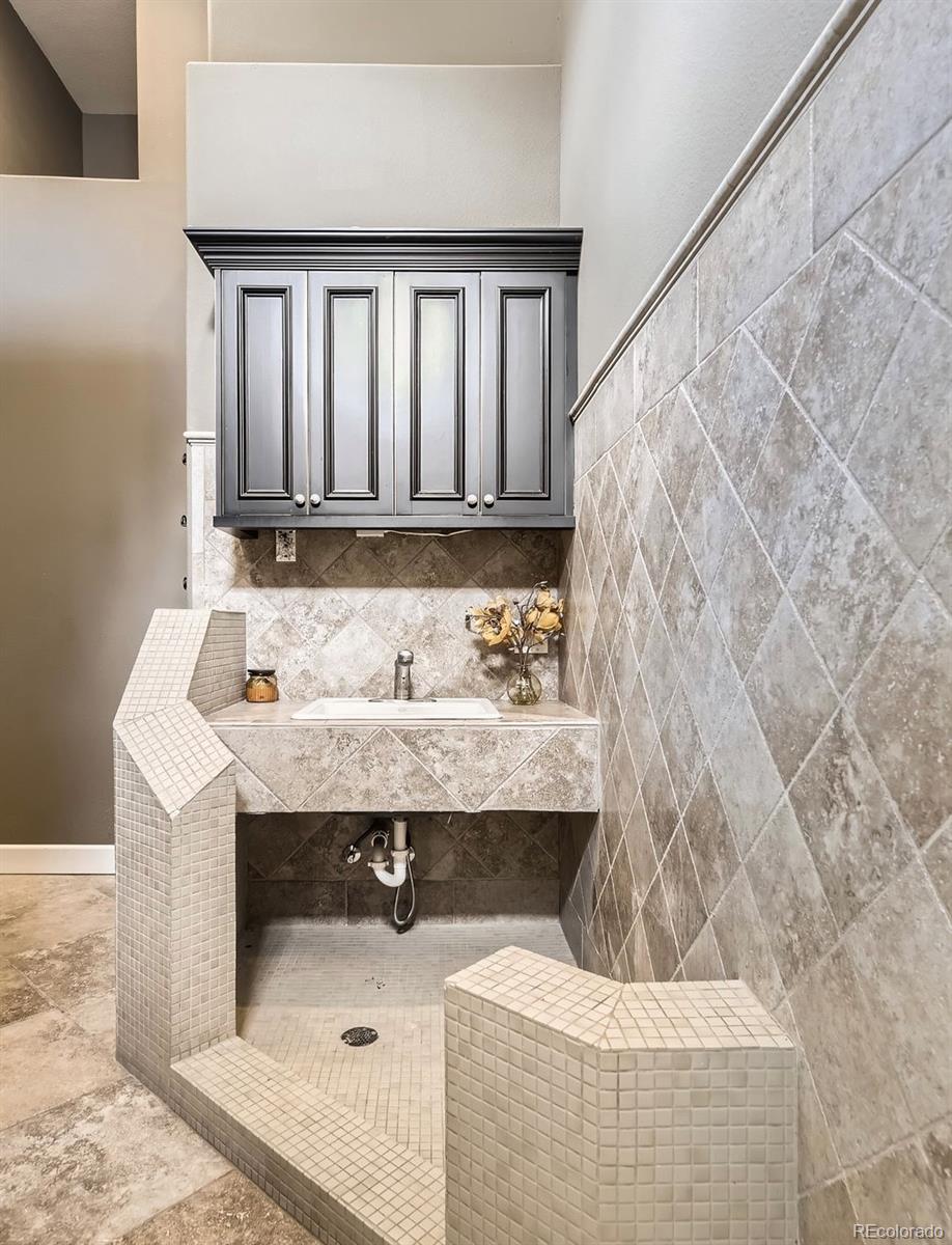 11274 East Manitou Road Franktown, CO 80116 - Photo 29 of 46 a bathroom with a sink and a mirror