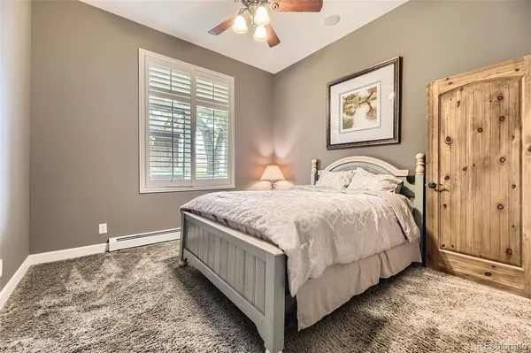 a bedroom with a bed lamp and a window
