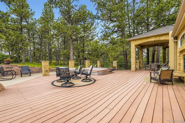 a view of a patio with dining table and chairs barbeque with wooden floor and fence