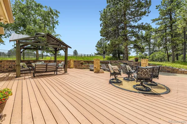a view of a patio with table and chairs and wooden floor