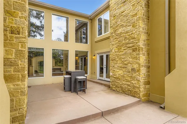 a view of front door of house with outdoor seating