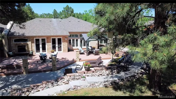 a view of a house with a yard patio and sitting area