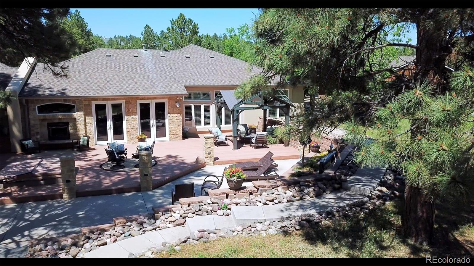 11274 East Manitou Road Franktown, CO 80116 - Photo 7 of 46 a view of a house with a yard patio and sitting area