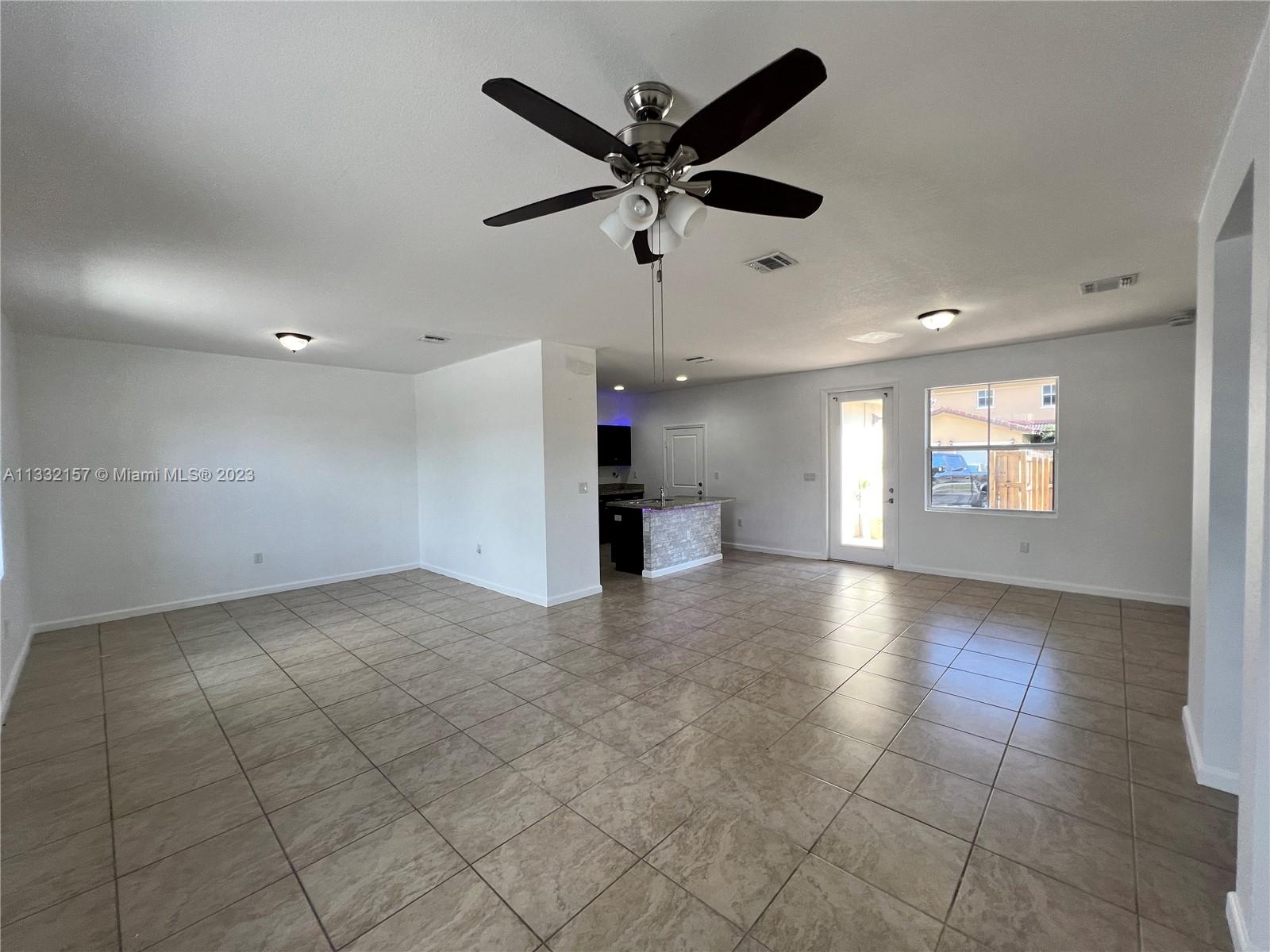 24257 Southwest 117th Avenue Homestead, FL 33032 - Photo 11 of 27 a view of an empty room with a window