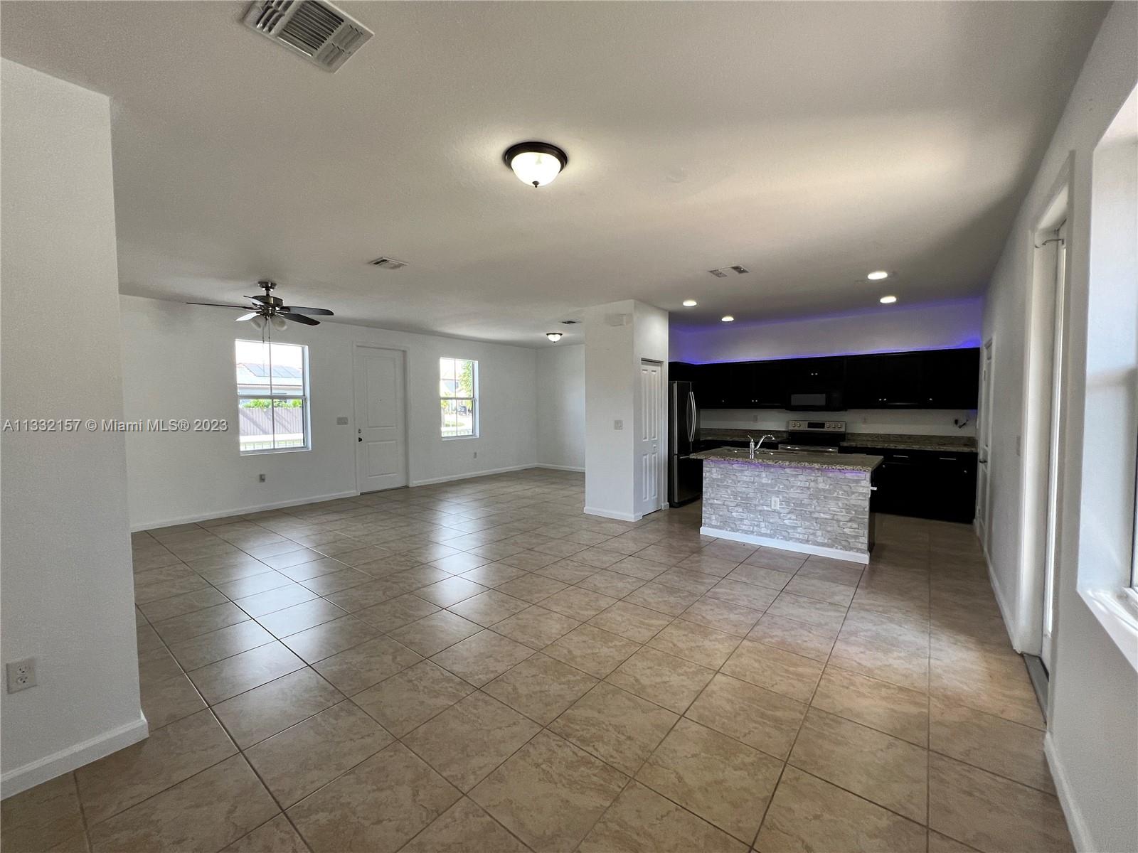 24257 Southwest 117th Avenue Homestead, FL 33032 - Photo 12 of 27 a view of a kitchen with a sink and a stove top oven
