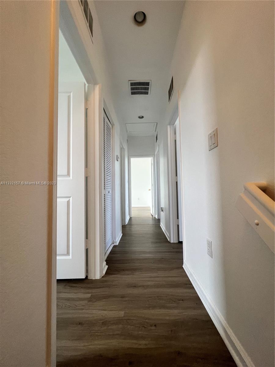 24257 Southwest 117th Avenue Homestead, FL 33032 - Photo 17 of 27 a view of a hallway with wooden floor