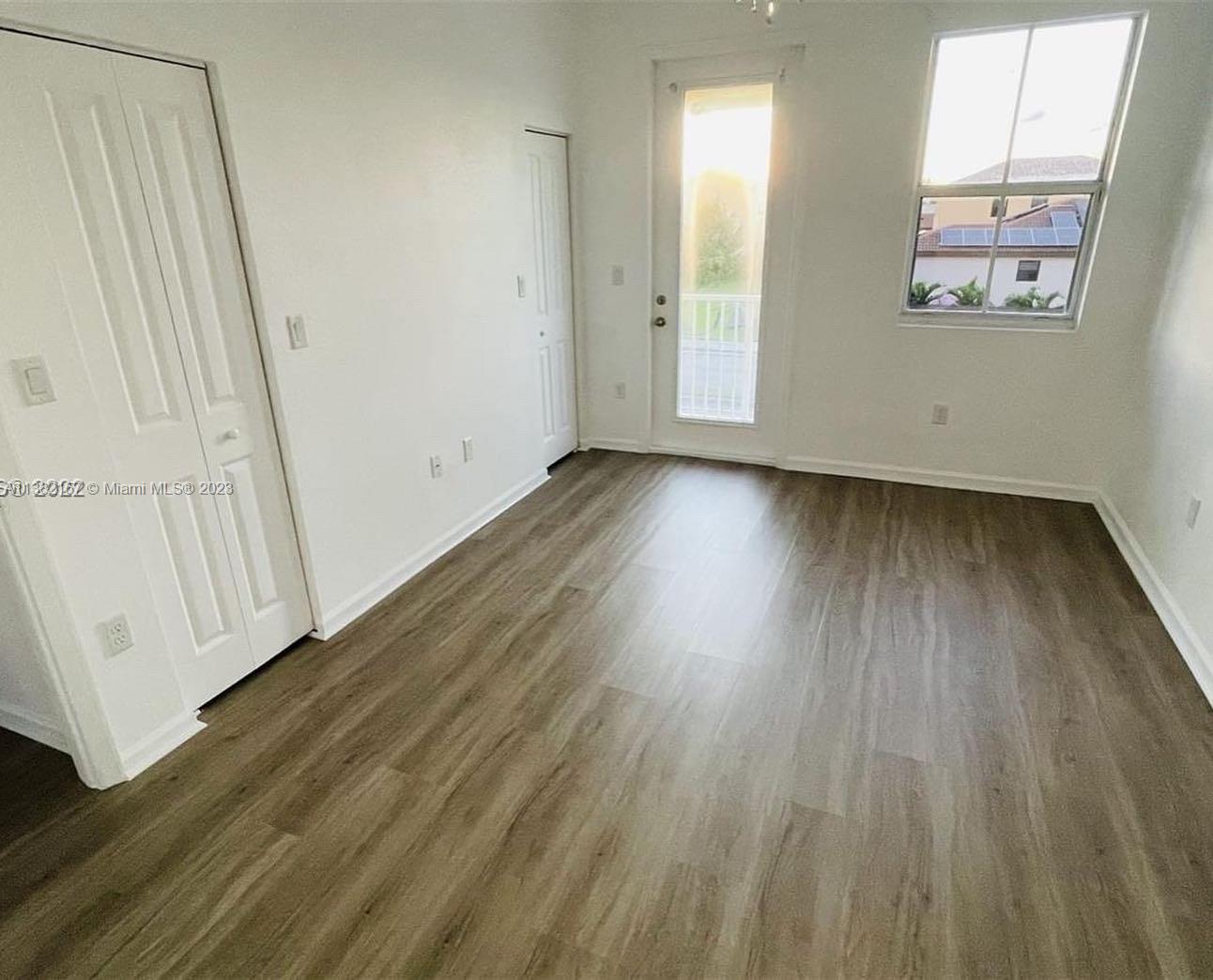 24257 Southwest 117th Avenue Homestead, FL 33032 - Photo 18 of 27 a view of a room with wooden floor and window