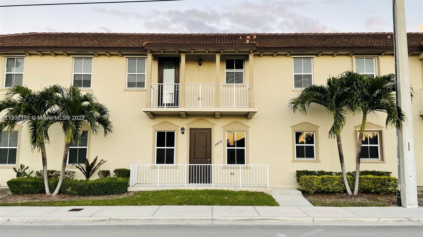 24257 Southwest 117th Avenue Homestead, FL 33032 - Photo 2 of 27 a house that has a palm tree in front of it