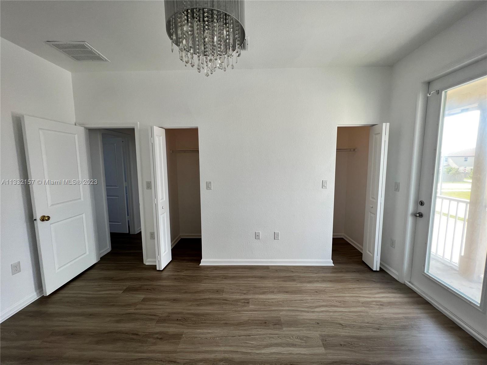 24257 Southwest 117th Avenue Homestead, FL 33032 - Photo 21 of 27 an empty room with wooden floor and window