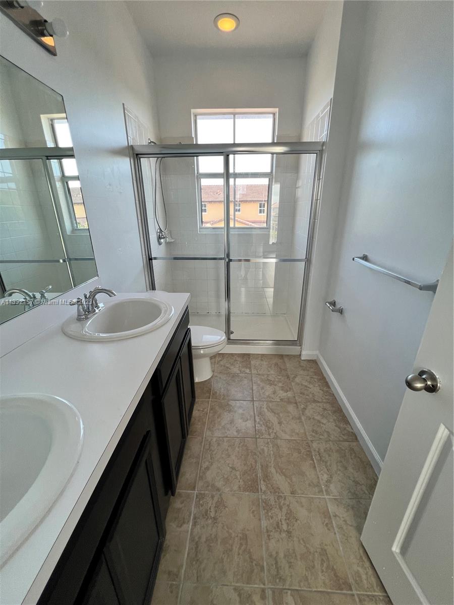 24257 Southwest 117th Avenue Homestead, FL 33032 - Photo 22 of 27 a bathroom with a sink a toilet and shower