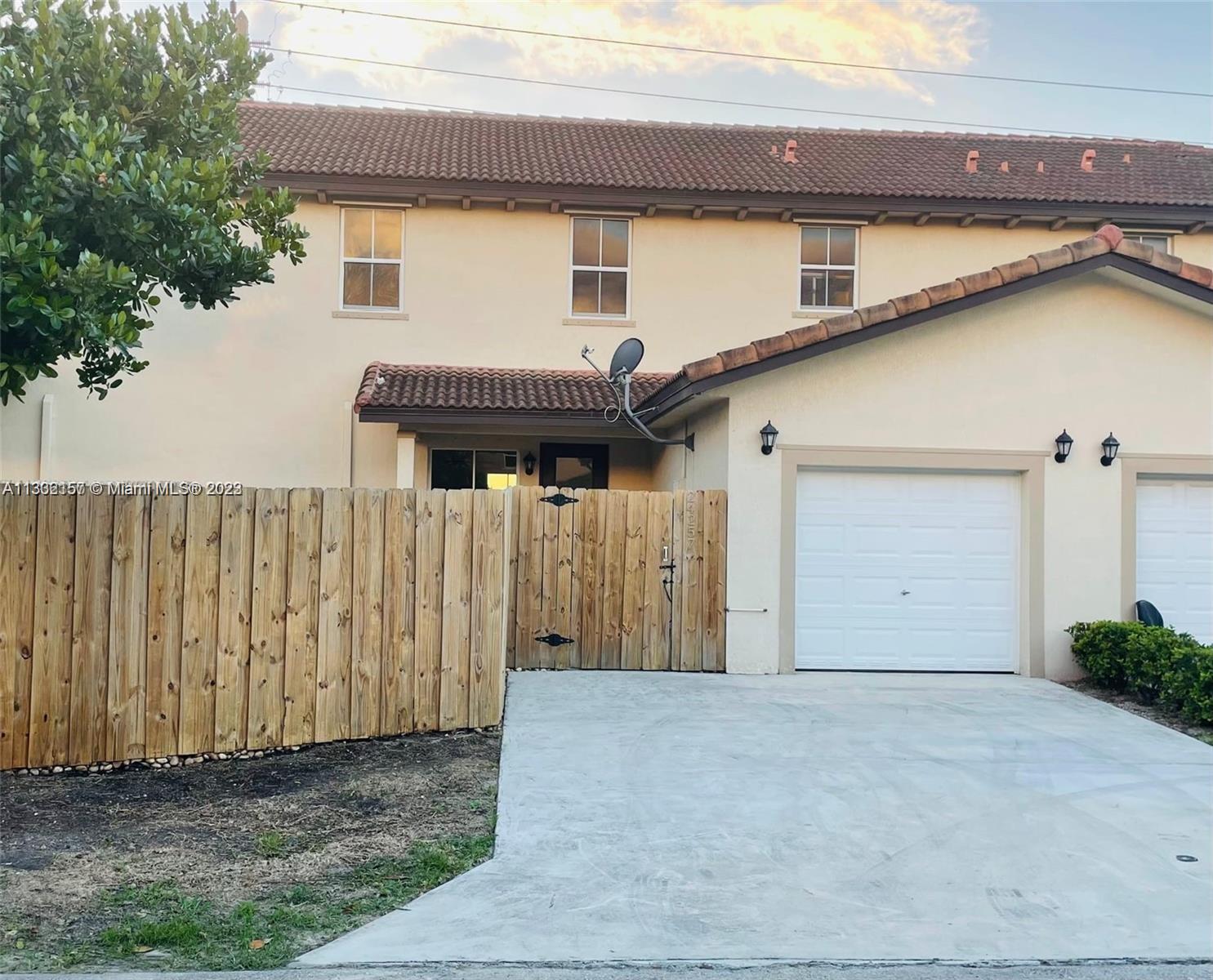24257 Southwest 117th Avenue Homestead, FL 33032 - Photo 3 of 27 a front view of a house with garage
