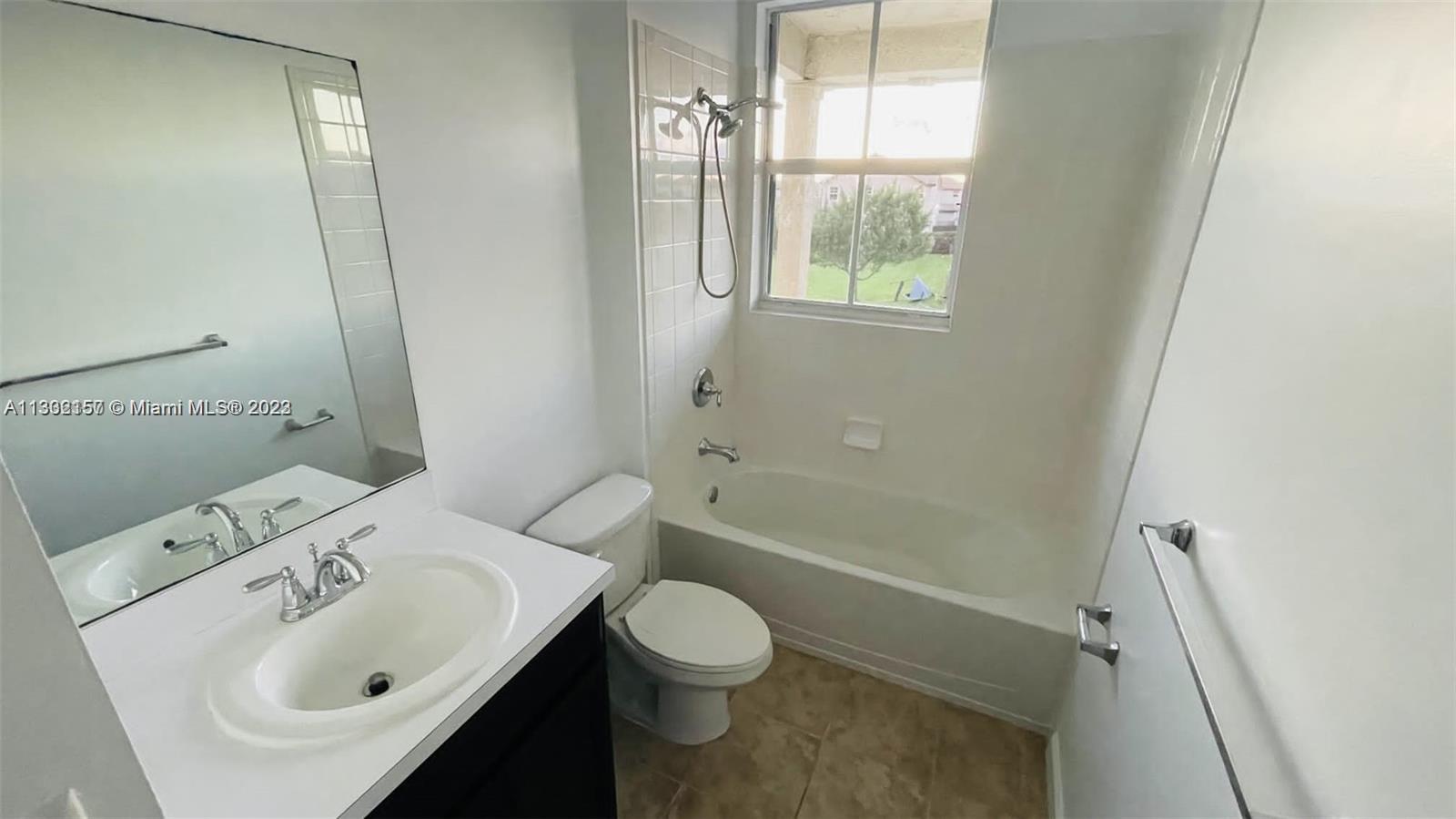 24257 Southwest 117th Avenue Homestead, FL 33032 - Photo 4 of 27 a bathroom with a sink toilet and shower