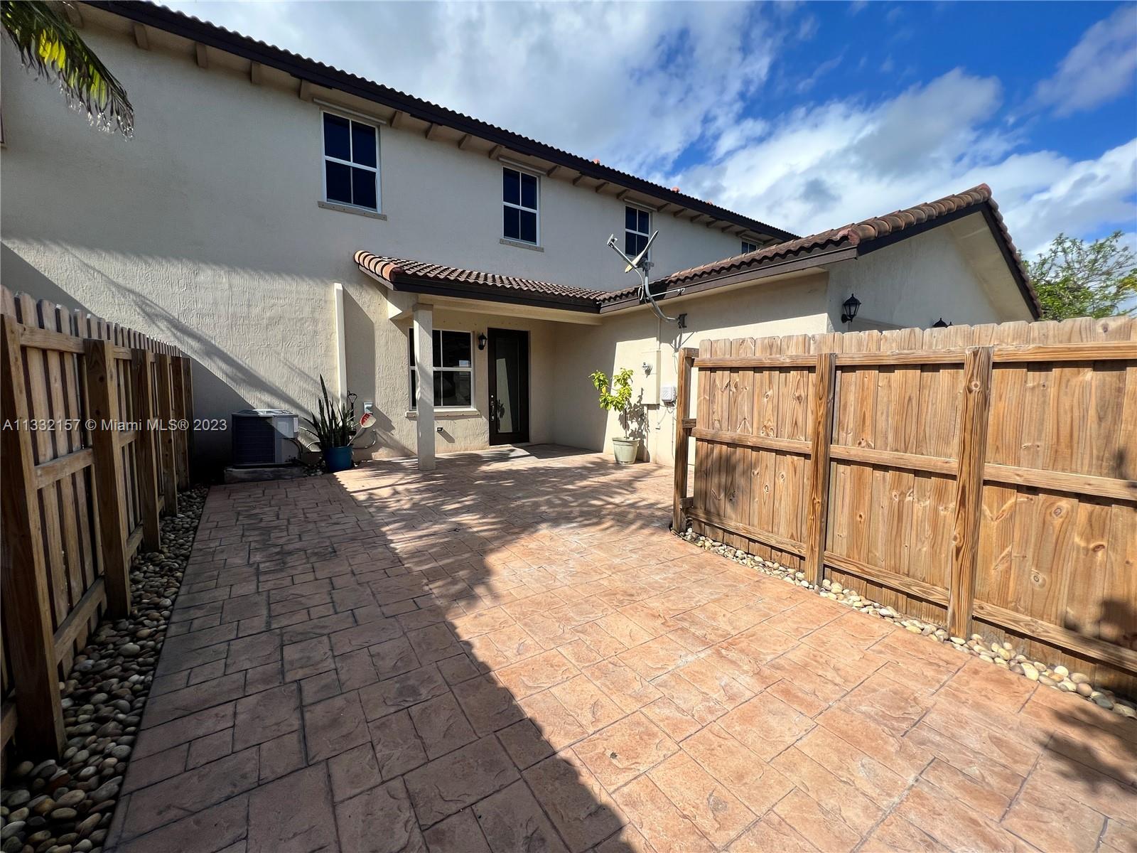 24257 Southwest 117th Avenue Homestead, FL 33032 - Photo 5 of 27 a view of a house with wooden fence