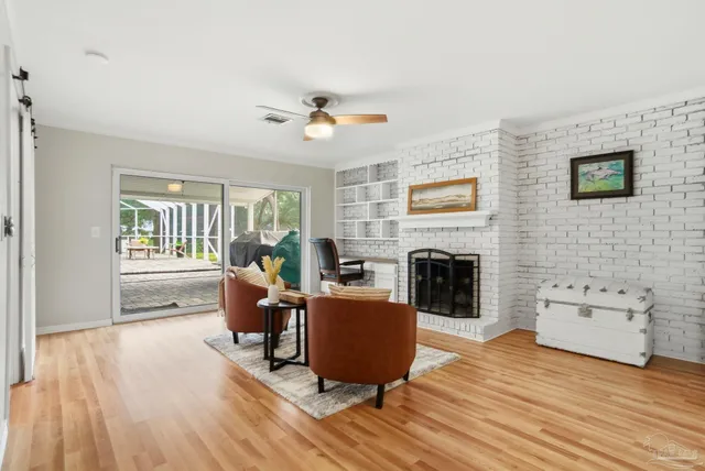 a living room with furniture wooden floor and a fireplace