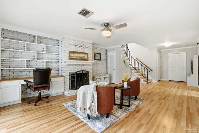 a view of a livingroom with furniture and a fireplace
