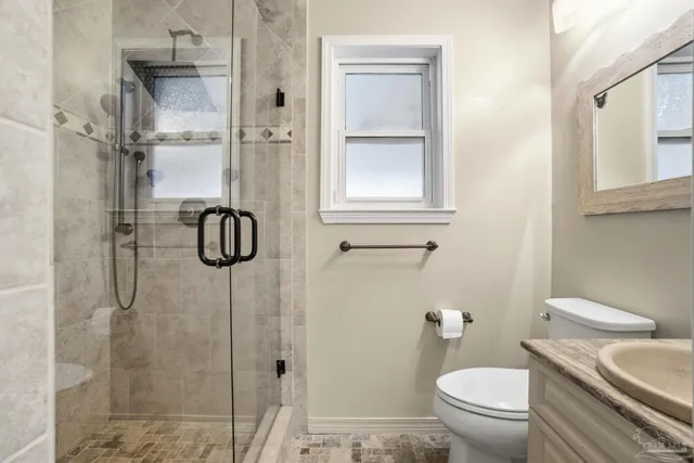 a bathroom with a toilet and a shower