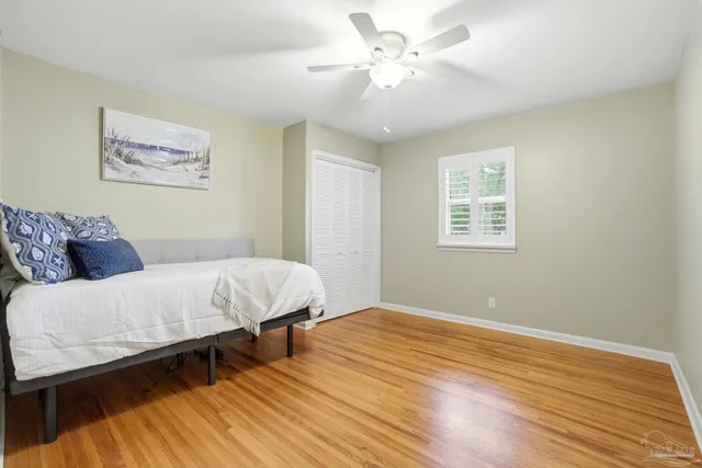 a bedroom with a bed and wooden floor