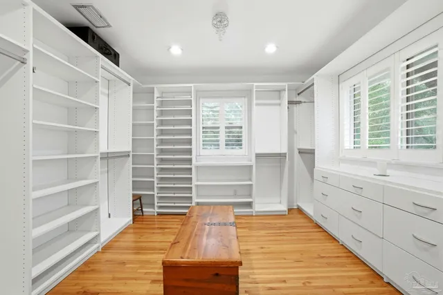 a room with wooden floor and windows