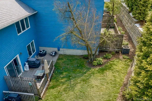 a backyard of a house with table and chairs