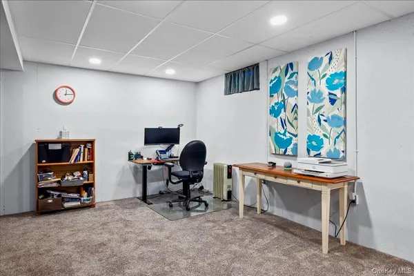 a living room with furniture and wall paintings