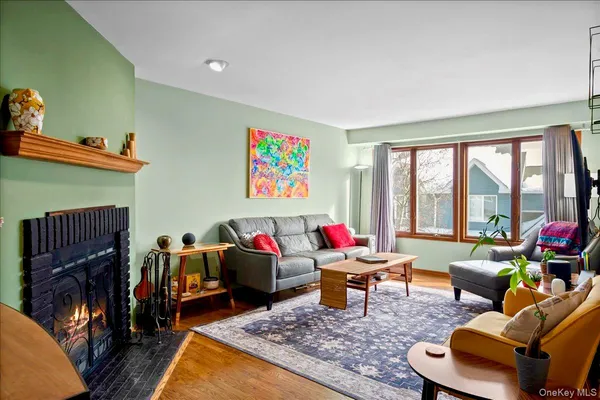 a living room with furniture a rug and a floor to ceiling window