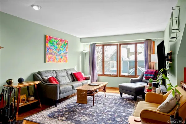 a living room filled with furniture and a floor to ceiling window