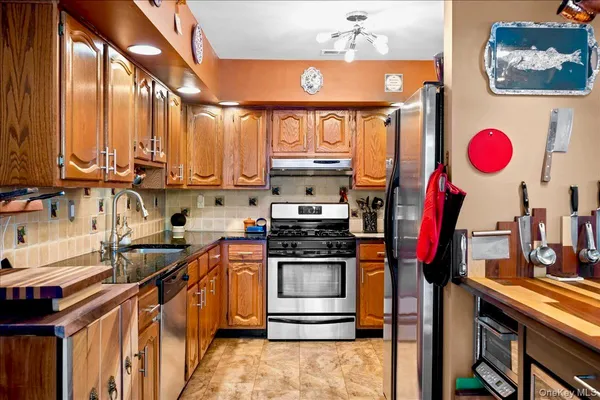 a kitchen with a stove a sink and a microwave