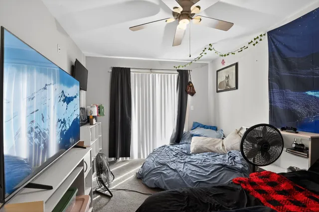 a bedroom with a bed and a chandelier