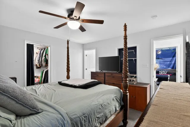 a bedroom with a bed and a flat screen tv