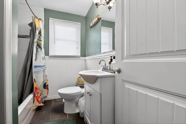 a bathroom with a sink a toilet and a mirror