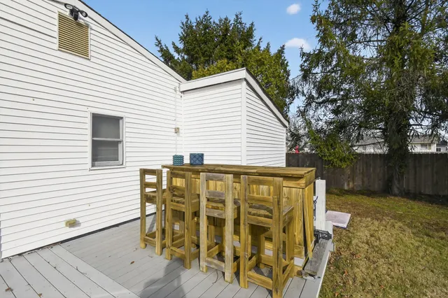a view of a house with wooden deck and backyard