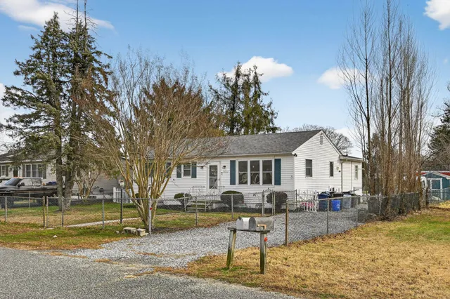 a view of a house with swimming pool and sitting area