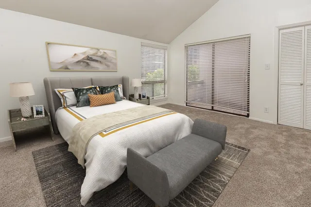 a bedroom with a bed and a couch