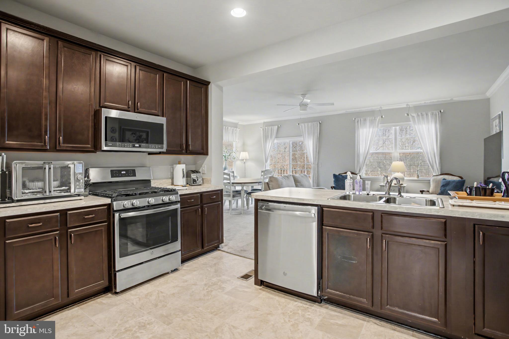 225 Patchwork Drive Stephenson, VA 22656 - Photo 15 of 32 Modern kitchen with rich wood cabinetry.